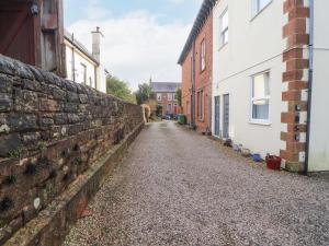 an alley between two houses and a brick wall at 3 Forest House in Penrith