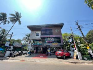 a red car parked in front of a building at RK Residency in Kozhikode