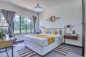 a bedroom with a large white bed and windows at The Spanish House in Centurion +62 photos