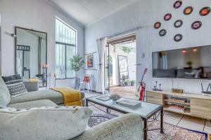 a living room with two couches and a tv at The Spanish House in Centurion