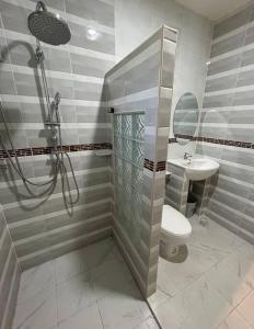 a bathroom with a shower and a toilet and a sink at Villa Patong in Ban Na Nai