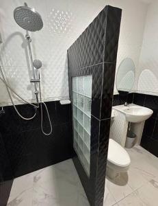 a bathroom with a shower and a toilet and a sink at Villa Patong in Ban Na Nai +11 photos