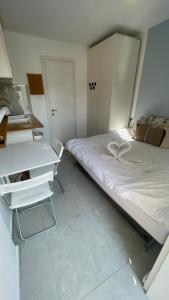 a small bedroom with a bed and a desk at Spring-shell in Beer Sheva