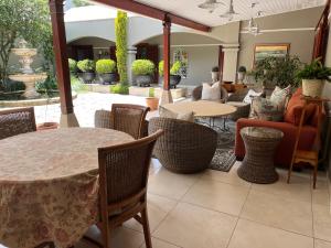 a restaurant with tables and chairs and a patio at The Courtyard at La Loggia in Nottingham Road