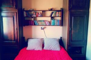 a bedroom with a red bed with two pillows at Vila Zabac - Ski Center Tornik in Zlatibor