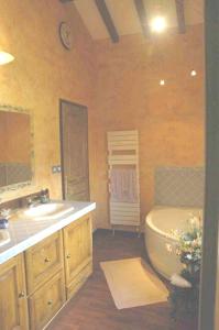 a bathroom with a tub and a toilet and a sink at Chalet de 5 chambres avec wifi a Aime a 1 km des pistes in Aime-La Plagne