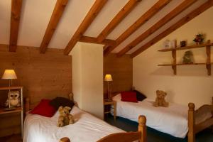 two beds with teddy bears sitting on them in a room at Chalet de 5 chambres avec wifi a Aime a 1 km des pistes in Aime-La Plagne