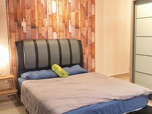 a bed with a yellow object on top of it at Mount Austin Palazio Homestay johor bahru in Johor Bahru