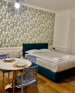 a bedroom with a bed and a table and chairs at Studio Stresa in Stresa