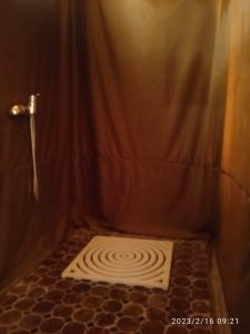 a bathroom with a shower with a shower curtain at Désert Man luxury Camp in Merzouga