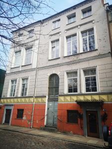a building on the corner of a street at Loft Apartment in Klaipėda