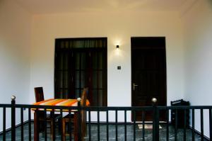 een eetkamer met een tafel en twee deuren bij Sigiri Heaven Villa in Sigiriya