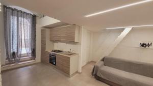 a living room with a couch and a kitchen at Casa Laura in Vieste