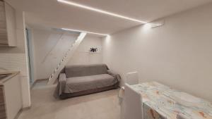 a white room with a bed and a staircase at Casa Laura in Vieste