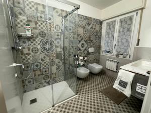 a bathroom with a shower and a toilet and a sink at VILLA TARA in Quercianella