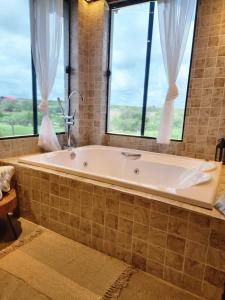 a bath tub in a bathroom with a window at Casa Campo - Domo do Matto in Garanhuns