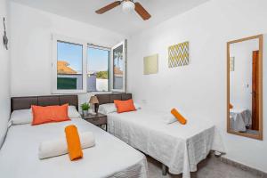 a bedroom with two beds and a mirror at Can Quique in Cala'n Porter +13 photos