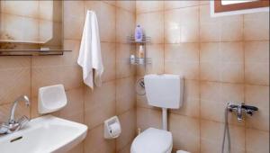 a bathroom with a toilet and a sink at Villa Kardi in Vlikhádha +26 photos