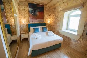 L-Eremita Boutique Hotel客房内的一张或多张床位