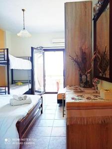 a bedroom with two bunk beds and a window at Irida Maria in Agios Ioannis Pelio