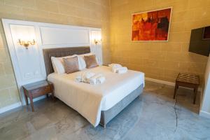 L-Eremita Boutique Hotel客房内的一张或多张床位