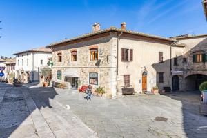a person walking in front of a building at Chianti Classico Home in Castellina in Chianti