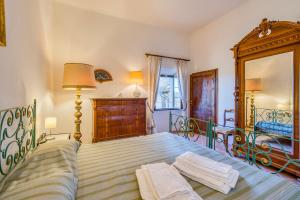 a bedroom with a bed with two towels on it at Chianti Classico Home Panoramic View - Happy Rentals in Castellina in Chianti