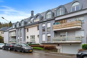 a building with cars parked in front of it at Beggen 2BR, Cozy, Modern Living in Luxembourg