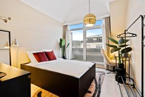 a hotel room with a bed and a window at Comfortable 2BR Apt in Prime Luxembourg Location in Luxembourg