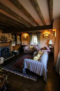 a living room with a couch and a fireplace at Characterful Yorkshire cottage, beautiful views in York