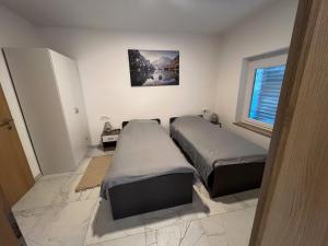 a bedroom with two beds and a window at Apartment Mandy in Rečica ob Savinji