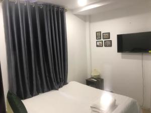 a bedroom with a bed with a black curtain at Hanoi Little Hotel in Hanoi +23 photos