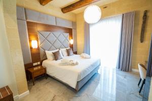L-Eremita Boutique Hotel客房内的一张或多张床位