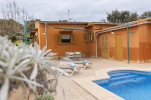 a house with a swimming pool in front of it at Yourhouse Villa Sa Caseta in Llubí