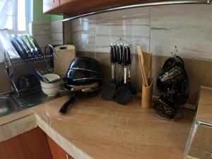 a kitchen counter with utensils on a counter top at Nyeri Nest Retreat - One Bedroom in Nyeri