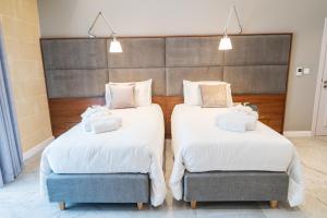 L-Eremita Boutique Hotel客房内的一张或多张床位