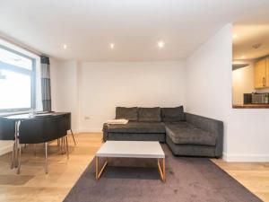 a living room with a couch and a table at Pass the Keys Spacious flat in Shoreditch in London