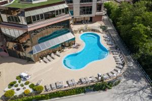 an aerial view of a swimming pool in front of a building at Hotel Premier Aqua - Adults Only in Vrdnik