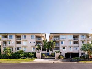 an apartment building with palm trees in front of it at The Sebel Noosa in Noosa Heads