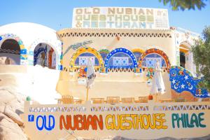 a building with a sign that reads old nigerian customs restaurant at Old Nubian guest house in Aswan