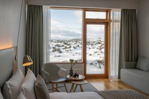 a hotel room with a view of a snow covered mountain at Silica Hotel at Blue Lagoon Iceland in Grindavík