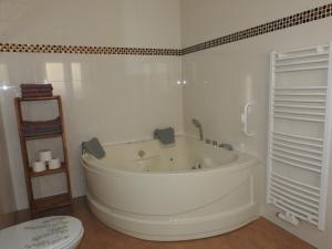 a white bath tub in a bathroom with a toilet at Ferienwohnungen am Hauptplatz in Pirna +237 photos