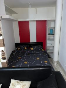 a bedroom with a bed and a red and white wall at RESIDENCE MELINDA in Dijon