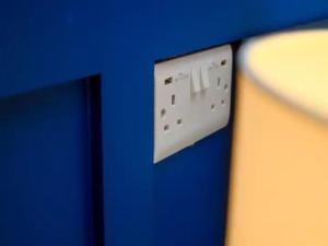 a wii remote control on a blue wall at Pass the Keys Stonebow room at Tavmar Apartments in Lincoln