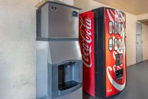 una máquina de coca cola junto a una máquina de refrescos en Suburban Studios International Drive, en Orlando