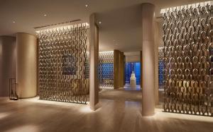een lobby met een grote metalen wand bij Park Hyatt Bangkok in Bangkok