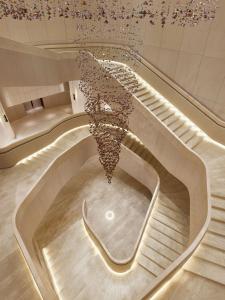 a staircase in a building with a chandelier at Park Hyatt Bangkok in Bangkok