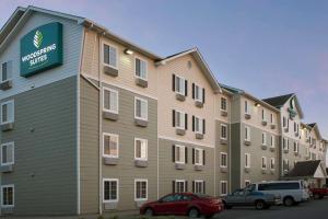 a large building with cars parked in front of it at WoodSpring Suites Johnson City in Johnson City