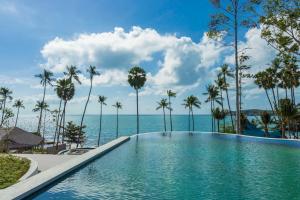 a swimming pool with the ocean in the background at Hyatt Regency Koh Samui- SHA Extra Plus in Chaweng