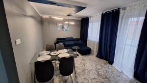 a living room with a table and a couch at CentrumGorzów in Gorzów Wielkopolski